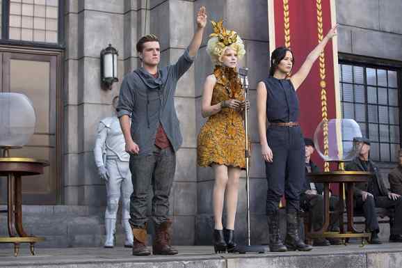 Peeta and Katniss saluting District 12 after they have been chosen to participate in the 2nd Hunger Games. 