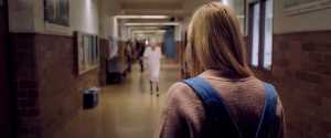 The creature pursues Jay down the halls of her school.