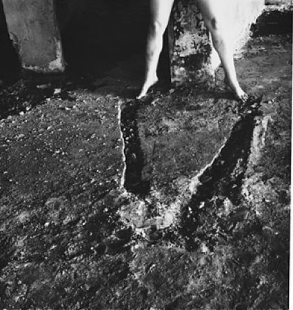 "From Angel Series, Rome" (1977-78) In this image, Woodman's legs mirror a deep, v-shaped groove in the ground, where it is implied that she fell to earth. It is widely considered one of Woodman's most humorous works, as the artist jokingly praises herself, implying the impossible.