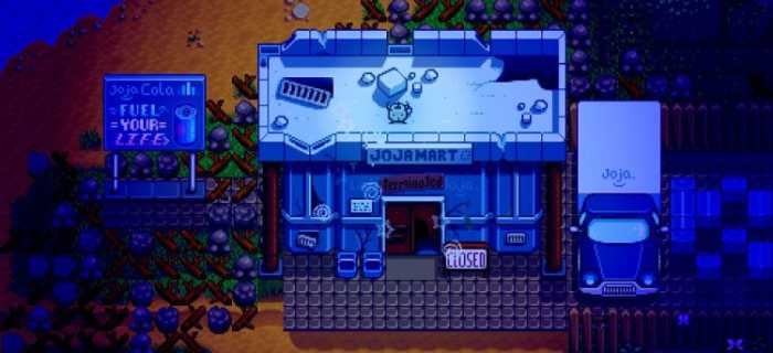 A screenshot from Stardew Valley, showing an abandoned building with a sign saying 'Jojamart'. There is a truck and a sign advertising Jojacola next to it, and a small forest spirit on the roof.