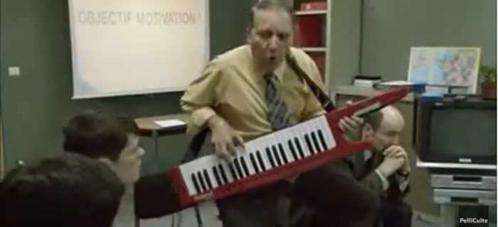 Gilles playing his keyboard during a motivational meeting