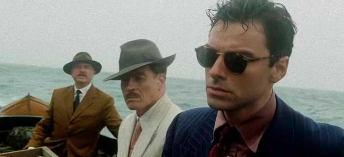 Philip Lombard (Aidan Turner) with Dr. Edward Armstrong (Toby Stephens) and General MacArthur (Sam Neill)